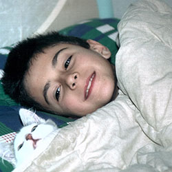Andrea as a child in the early 2000s with his cat Ciorts